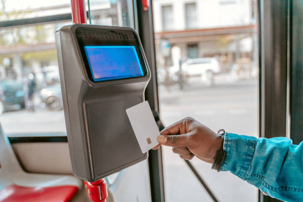 Hand holding card near reader in bus
