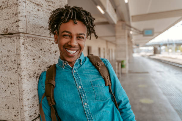 istock African guy smiling at camera on train station 1417721468