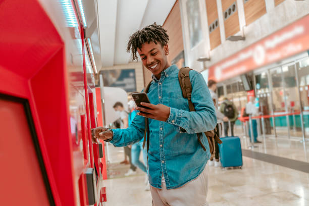 istock Guy smiling in smartphone touching self-service terminal 1417721499