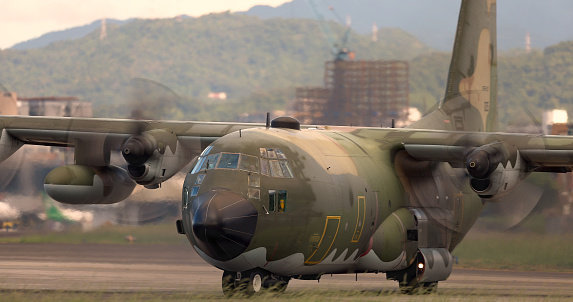 A Lockheed C-130 Hercules of the Royal Netherlands Air Force parked on a platform at the Dutch Air Force Base Eindhoven. The C-130 has a special tail decoration celebrating 25 years of service.