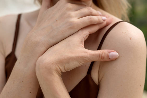 istock close-up of woman's hands folded on her shoulder 1417724770