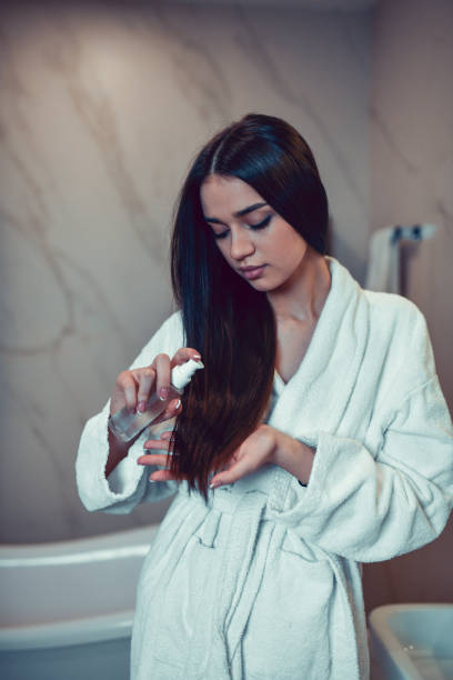 istock Hair Care Routine By Cute Female In Bathroom 1417725904