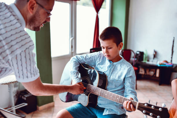 istock Guitar Strumming Lesson For Young Students By Teacher 1417726220