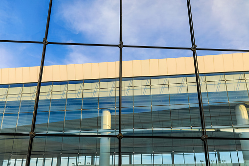 Glass curtain wall mapping and blue sky and white clouds