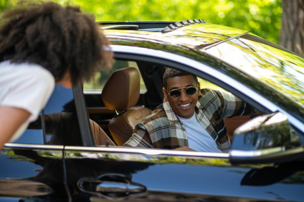 istock Young woman talking to driver and asking the way 1417731912