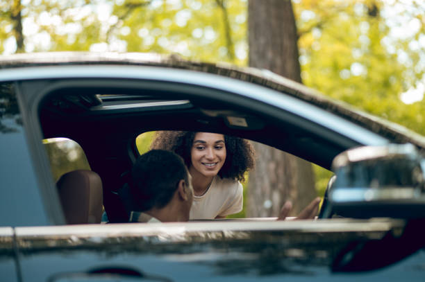 istock Hitchhiker talking to a car driver on the road 1417731917