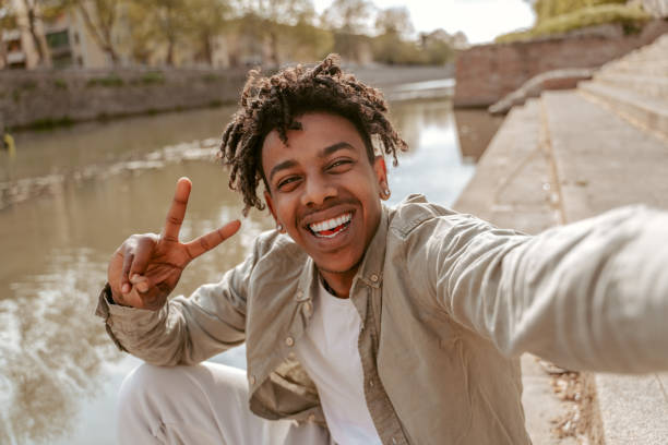 istock Guy smiling at camera showing freedom sign 1417736977