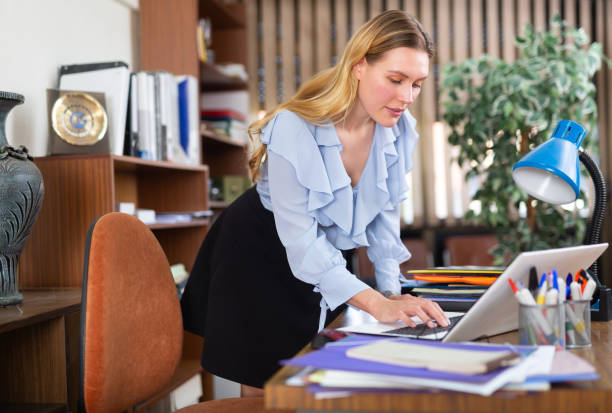 istock Successful businesswoman working with paperwork and laptop 1417739532