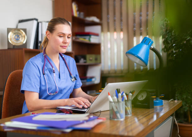 istock Woman doctor sitting at workplace with computer in office 1417739584