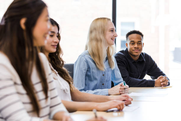 istock Diverse university students smile as they listen to lecture 1417742159