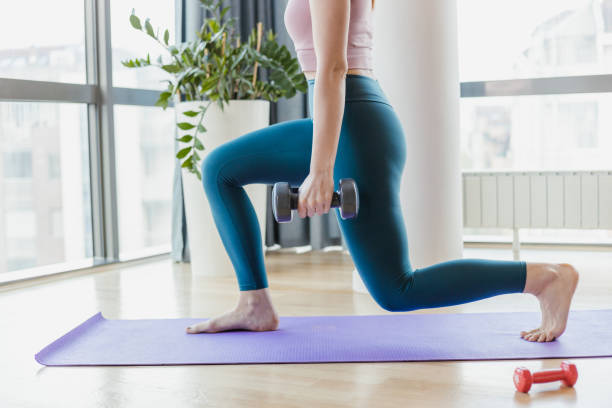 istock Athletic woman doing squats with weights 1417747416