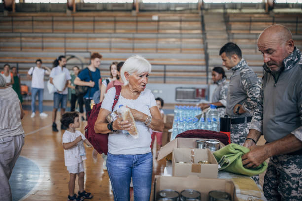 istock Civilians receiving donations after natural disaster 1417749813