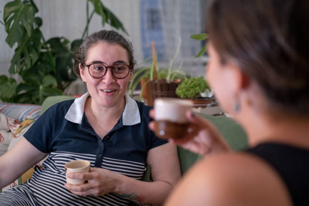 istock Two women are having a sincere conversation on the sofa 1417750229