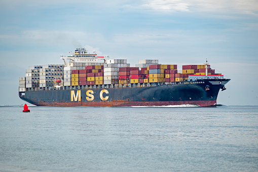 Charleston, SC, USA - August 24, 2022: Barbara, a 304-meter container ship owned by Mediterranean Shipping Company and flagged to Panama, sails into Charleston Harbor.