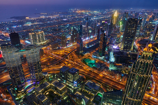 Aerial view of the large intersection between Sheikh Zayed Road and Al Safa Street at sunset. Dubai downtown by night. United Arab Emirates.