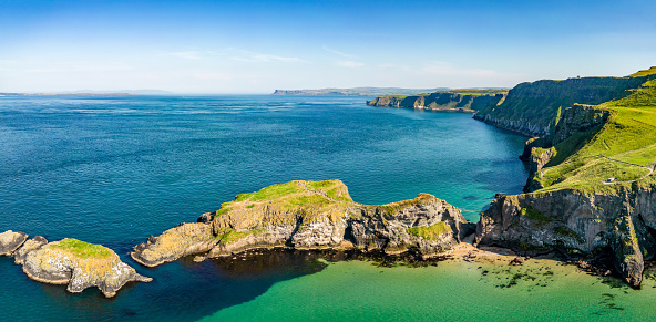 Panorama of Carrick-A-Rede Coastline in Northern Ireland - with the rope bridge between the mainland and island