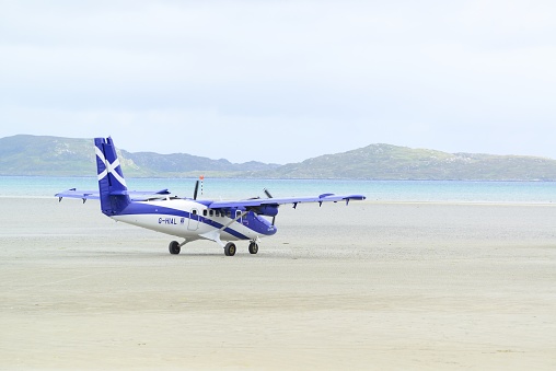 A Loganair Viking DHC-6-400 Twin Otter taxiing before take-off at Barra Airport(Scotland,UK),  believed to be the only airport in the world where scheduled flights use a tidal beach as the runway.