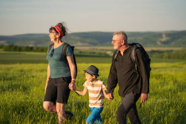 istock Mature backpackers holding hands with their grandson 1417753340