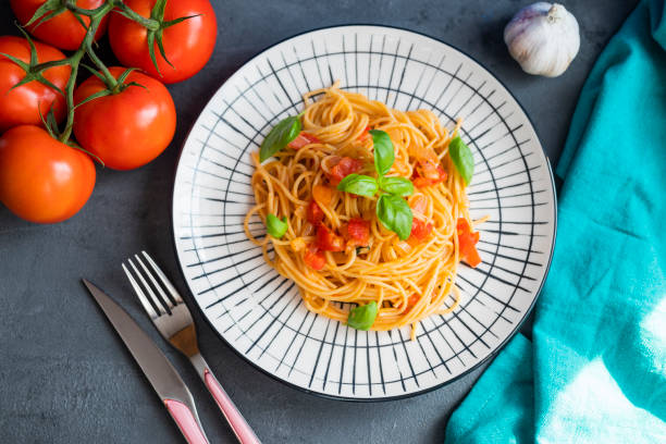 istock Italian pasta in a restaurant with tomato sauce and basil 1417753722