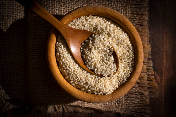istock Sesame seeds spoon on old background 1417755145