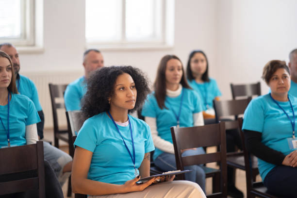 istock Charity workers listening in a team meeting 1417756350