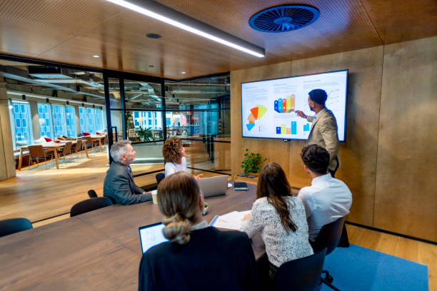 istock Man giving a big data presentation on a tv in a board room 1417762250