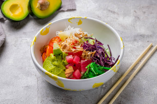 istock Ahi poke with tuna fresh tomatoes, cucumbers and avocado with chukka and rice on grey table 1417763421
