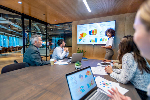 istock Woman giving a big data presentation on a tv in a board room. 1417763490
