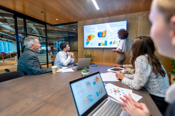 istock Woman giving a big data presentation on a tv in a board room. 1417763492
