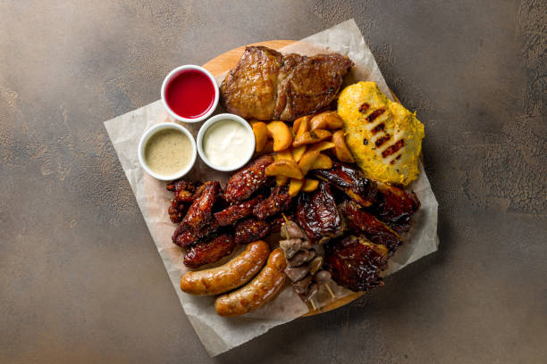 istock assorted beer sausages and meat with sauces on the board top view on brown concrete table 1417763552