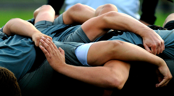 Rugby football players form a scrum as they pack closely together with their heads down and look for the ball, in Beltsville, Maryland.