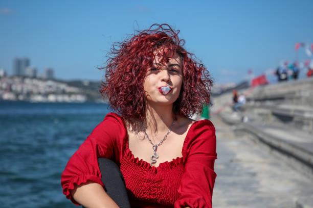 Redhead girl chewing gum on the street