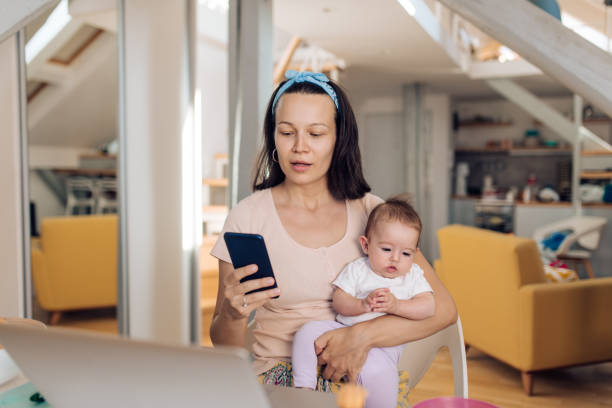 istock Mother With Baby Working In Office At Home 1417780771