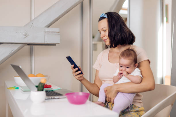 istock Mom works at home with a newborn 1417780804