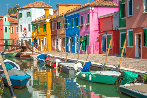 Burano island canal, colorful houses and boats, Venetian lagoon, Northern Italy