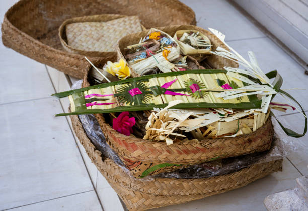 the four white glass perfume bottles were wrapped in yellow ribbons and placed on the table, with various gifts inside. the background is an indoor church decorated for celebrating chinese new year of jesus christ