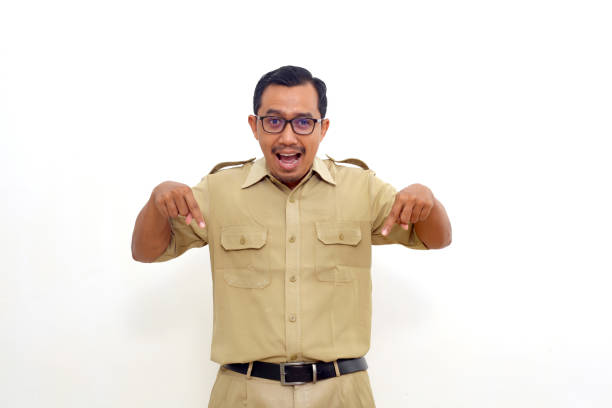 istock Amazed Indonesian government employees standing while pointing below. Isolated on white background 1417781176