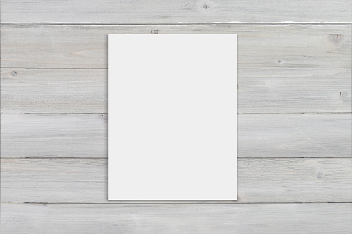 8.5x11 blank art print relaxing atop a gray wooden background. Includes clipping path to make it easy to add your design to the paper.