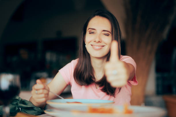 Happy Customer Enjoying Meal Course in a Restaurant