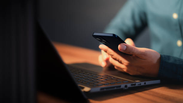 istock Closeup image of a man holding and using mobile phone or smartphone. 1417810227