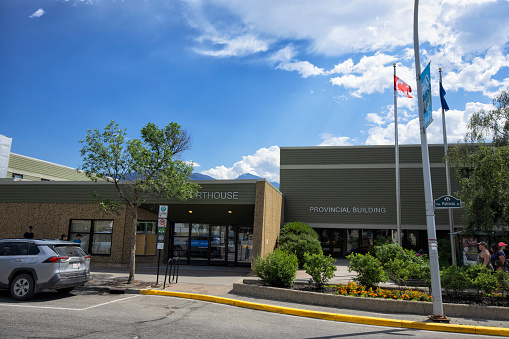 Jasper, Alberta, Canada - July 30, 2022: Street view of famous Jasper town center on a sunny afternoon. A Courthouse in the picture.