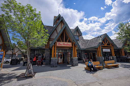 Jasper, Alberta, Canada - July 30, 2022: Street view of famous Jasper town center on a sunny afternoon. A Tim Hortons coffee shop in the picture.