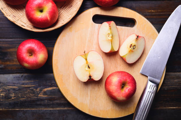 istock Sliced red apple on cutting wooden board 1417826812