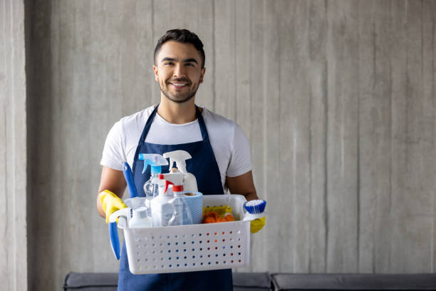 Professional cleaner holding a basket of cleaning products Portrait of a happy professional cleaner holding a basket of cleaning products and smiling at the camera - housework concepts maid housework stock pictures, royalty-free photos & images
