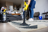 istock Professional cleaner vacuuming a carpet 1417833187