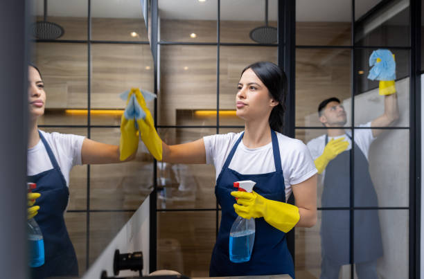 Team of professional cleaners cleaning a bathroom