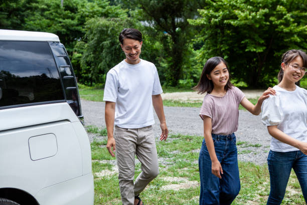 istock Father and two daughters walking through the campsite. 1417834314