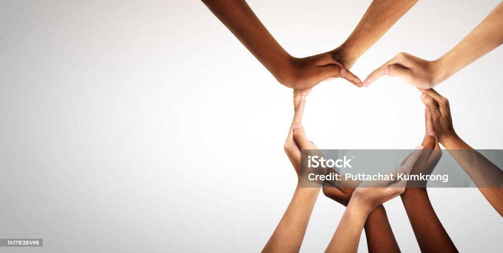 Unity and diversity are at the heart of a diverse group of people connected together as a supportive symbol that represents a sense of and togetherness. Unity and diversity are at the heart of a diverse group of people connected together as a supportive symbol that represents a sense of and togetherness. Symbol and shape created from hands. Heart Shape Stock Photo