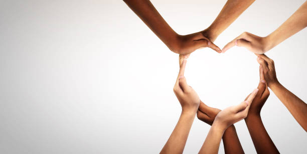 Unity and diversity are at the heart of a diverse group of people connected together as a supportive symbol that represents a sense of and togetherness. Unity and diversity are at the heart of a diverse group of people connected together as a supportive symbol that represents a sense of and togetherness. Symbol and shape created from hands. charity benefit stock pictures, royalty-free photos & images
