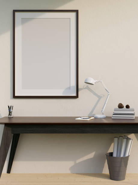 istock Minimal working space with classic dark wood work table and empty frame mockup on the white wall 1417838635